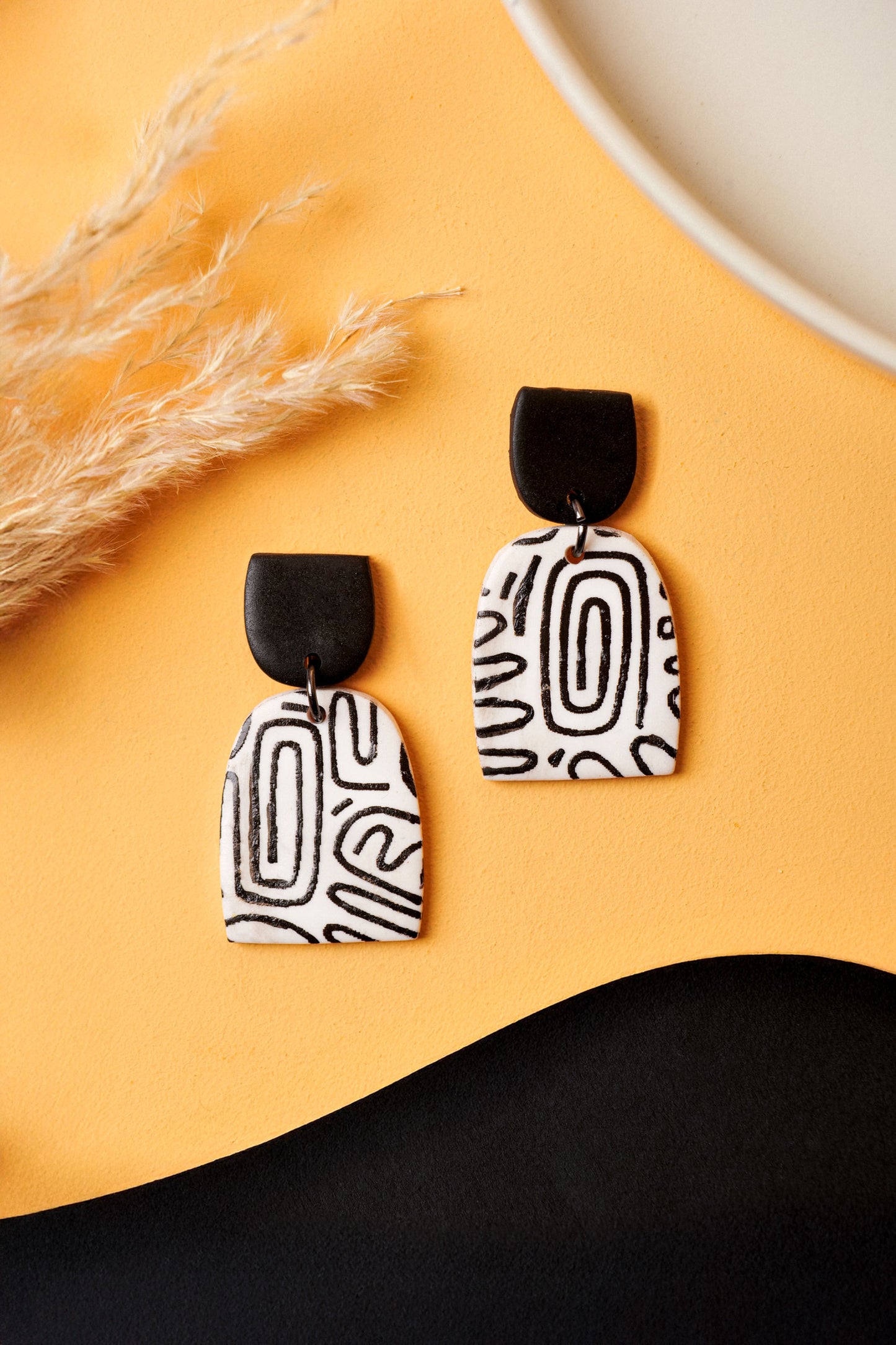 Black-on-white graffiti sketch earrings. Monochrome and graphic like the U-Bahn.