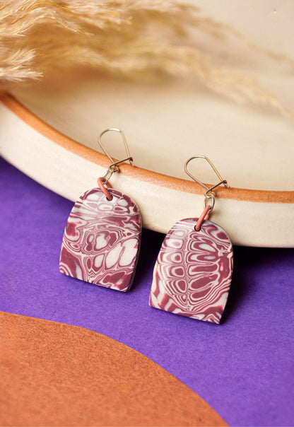 Dome earrings in soft burgundy marble. Calm, wearable contrast.