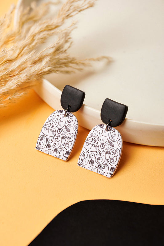 Cat doodle earrings with a bold black stud. A Berlin flea-market kind of cool.