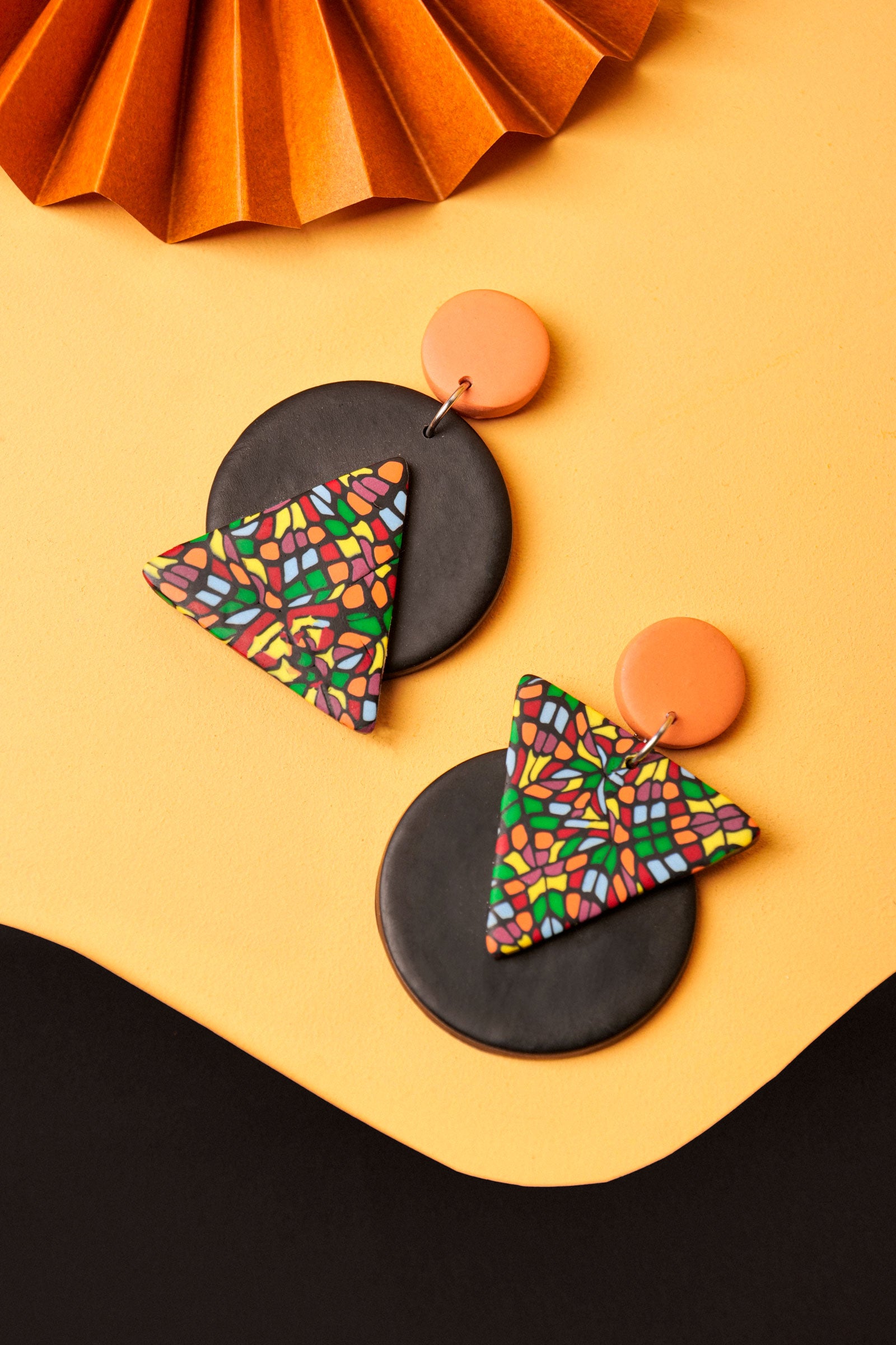 Triangle and circle drop earrings with bold contrast. Handmade mosaic pattern meets graphic form.