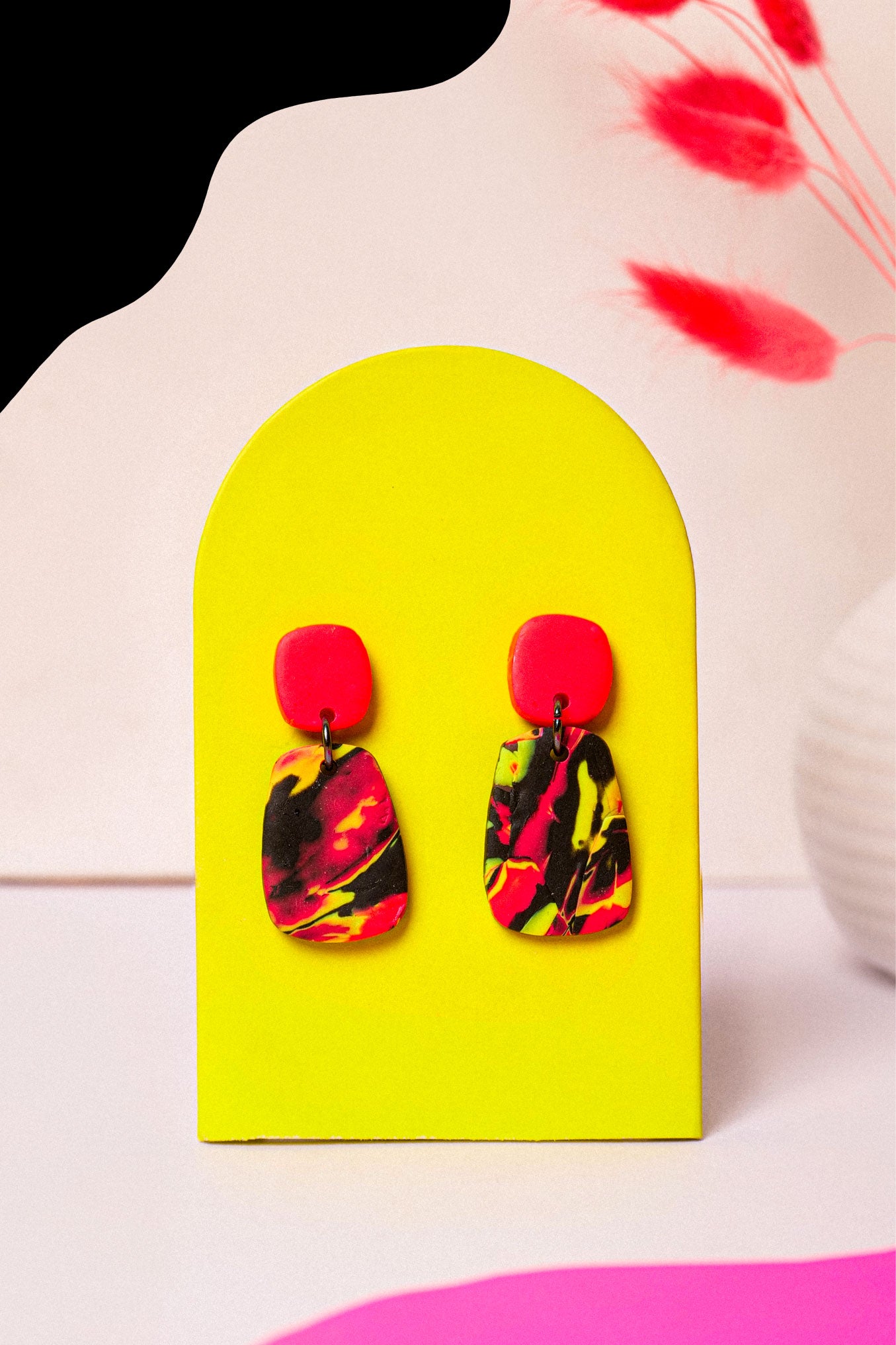 Neon swirl drop earrings in pink, lime and black. Lightweight, bold, and handmade in Berlin.