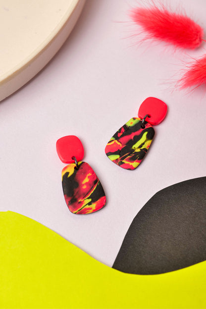 Neon swirl drop earrings in pink, lime and black. Lightweight, bold, and handmade in Berlin.