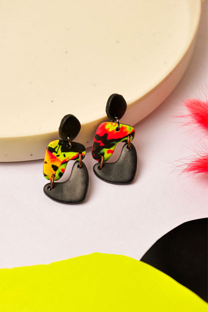 Neon swirl drop earrings in pink, yellow, and black. Like Berlin club nights — loud, layered, and never quite the same.