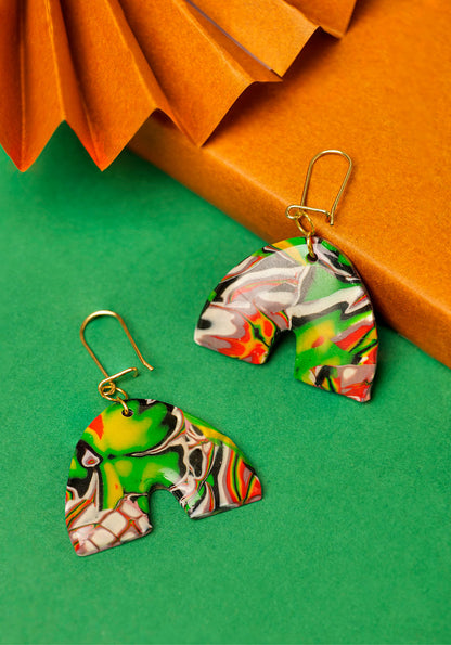 Red, black and green graffiti-style clay arches. Handmade chaos, shaped with care.