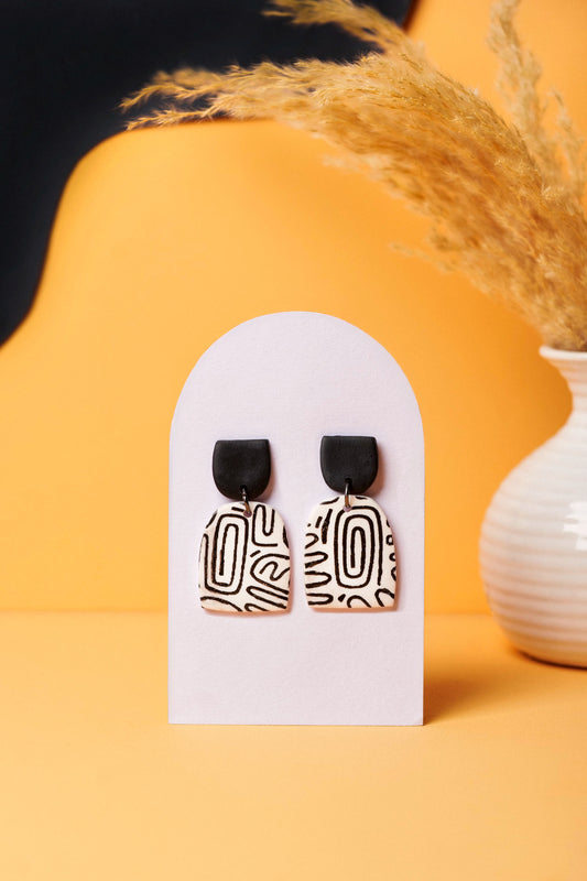 Black-on-white graffiti sketch earrings. Monochrome and graphic like the U-Bahn.