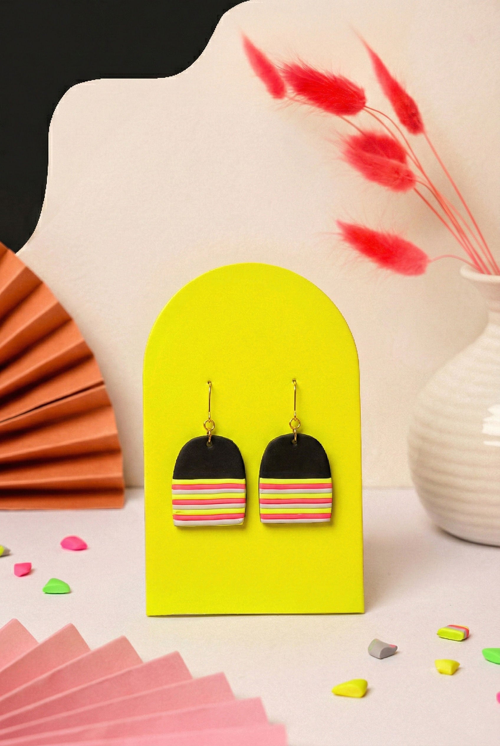Graphic dome earrings in layered neon. Lightweight but hard to ignore.