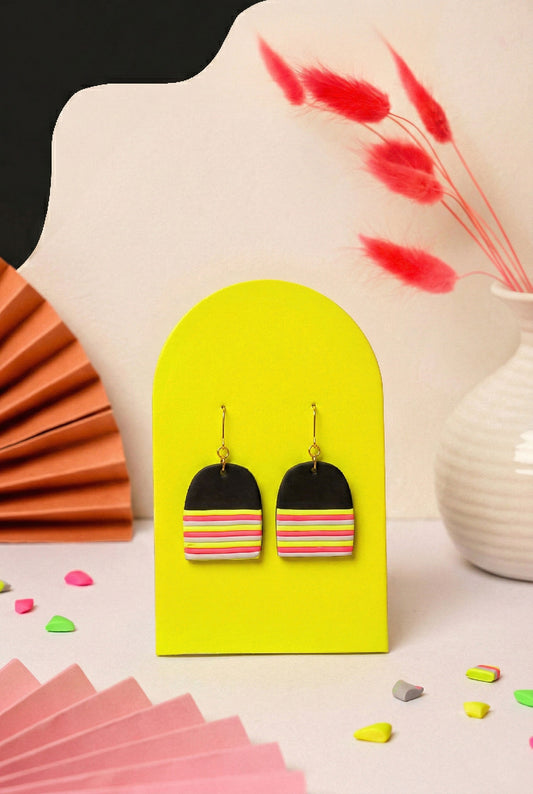 Graphic dome earrings in layered neon. Lightweight but hard to ignore.