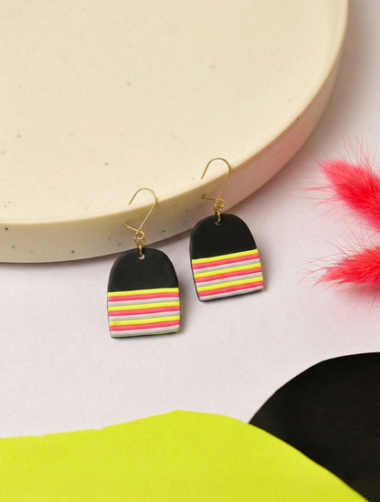 Graphic dome earrings in layered neon. Lightweight but hard to ignore.