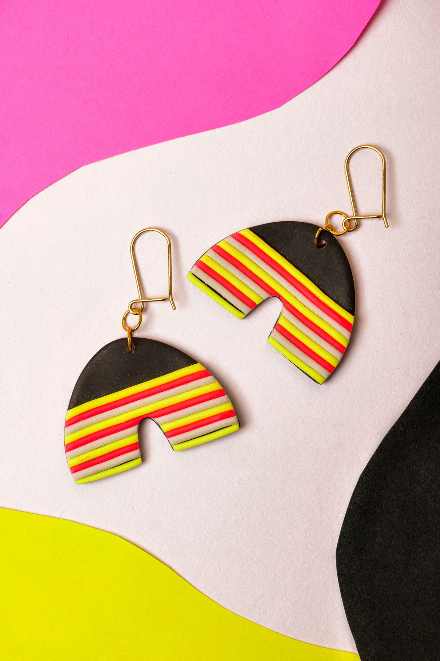 Neon striped clay arches for everyday party mode. Berlin colour, wearable shape.