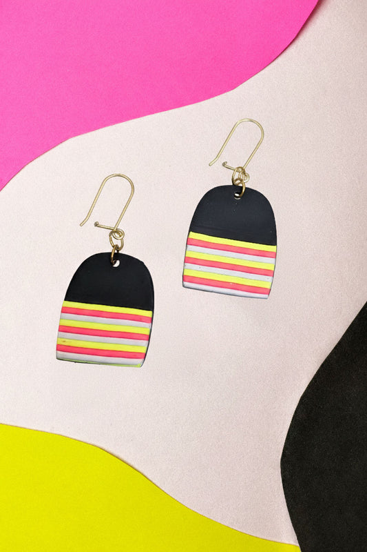 Graphic dome earrings in layered neon. Lightweight but hard to ignore.