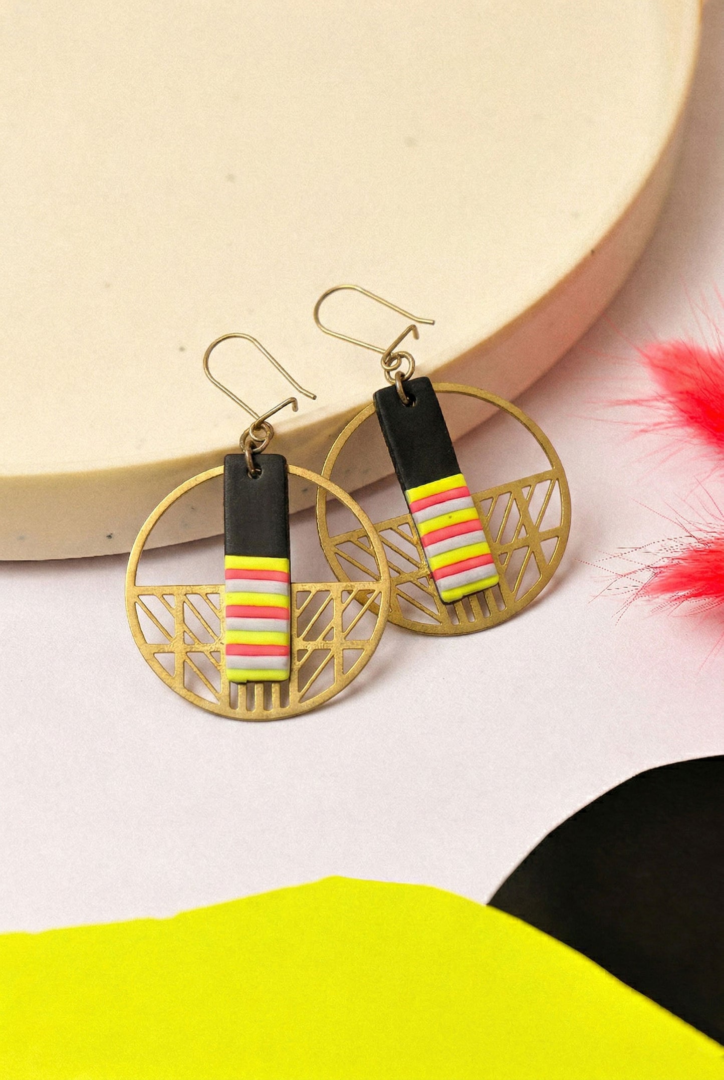 Statement striped clay in a gold hoop frame. Graphic but wearable.