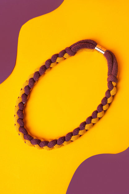 Braided textile necklace in deep red and mustard yellow. Lightweight statement for winter layering.